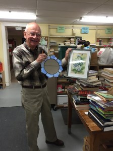 Don R. with a mirror and framed picture.
